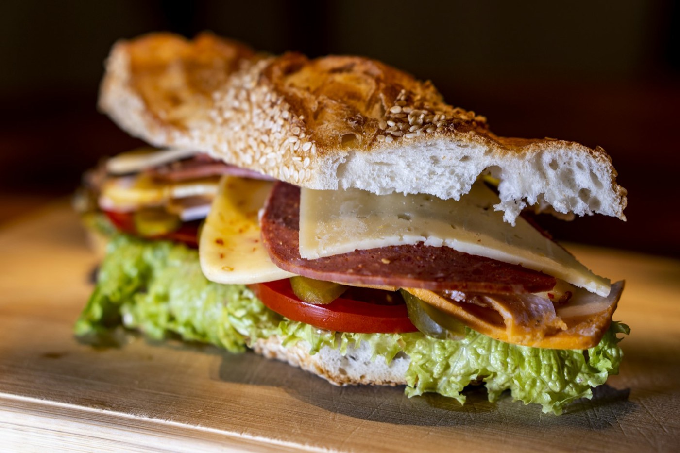 Deli sandwich stacked with lettuce, tomato, meats and cheese